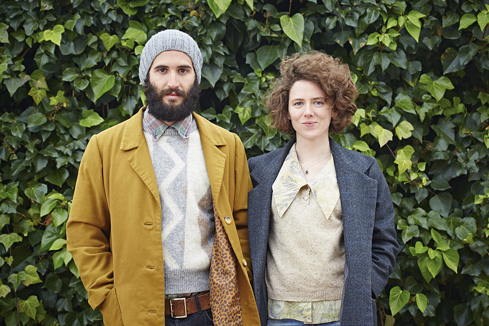 Smiling hipster student couple