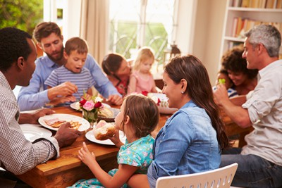 Family and friends sitting at a dining table