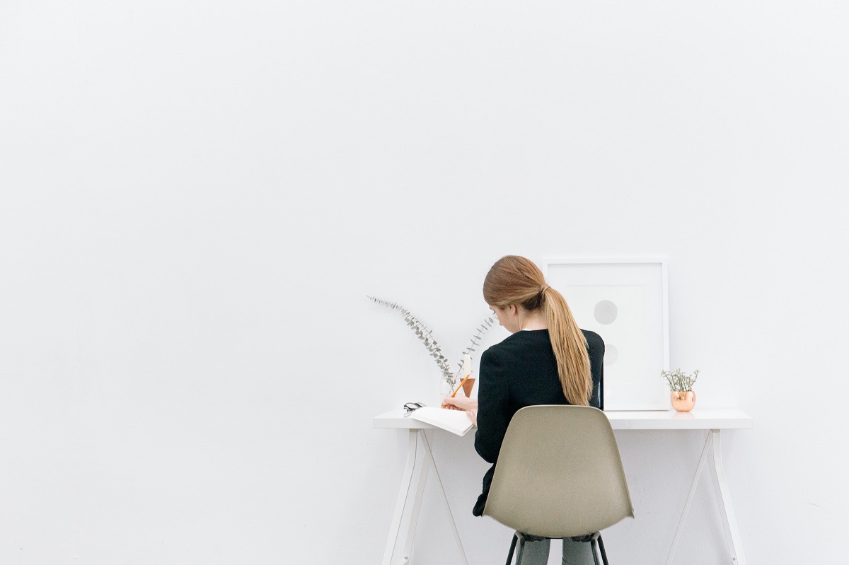 girl writing at desk