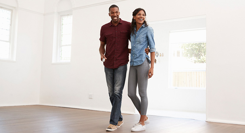 Young couple touring an empty house.