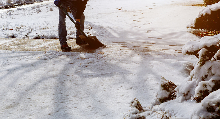 City service cleaning snow winter with shovel after snowstorm yard