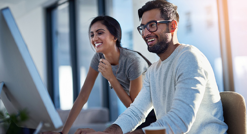 Two people working on a computer