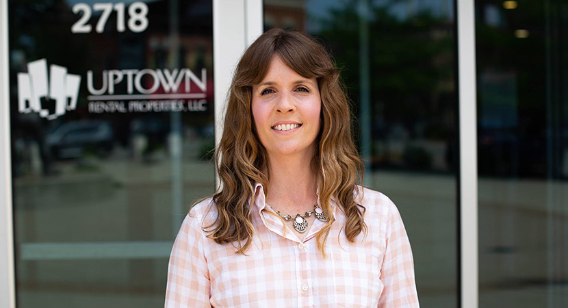 Angie Reynolds standing in front of the Uptown Rentals office