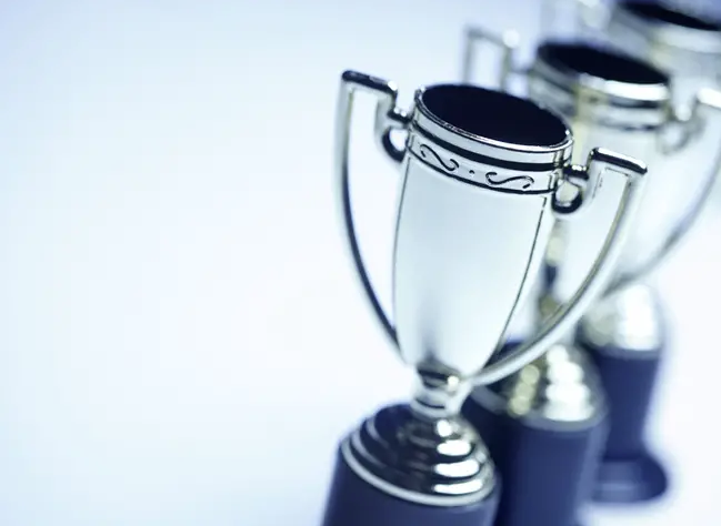 three awards on a table