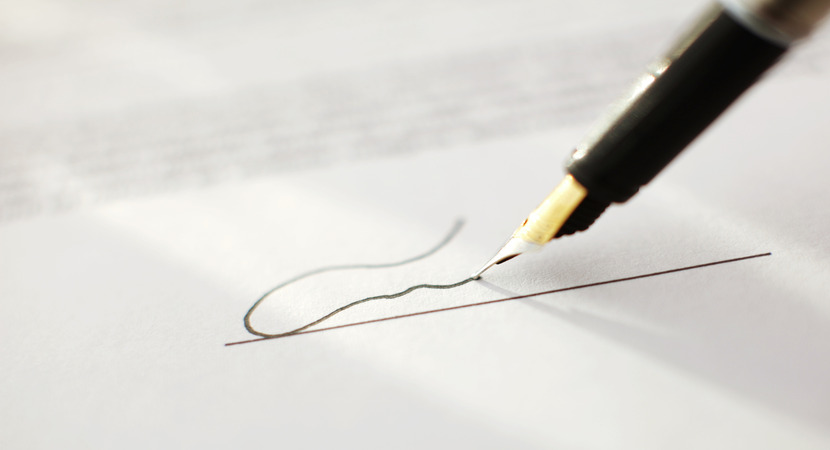 pen signing a document