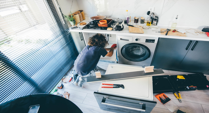 woman doing maintenance on washing machine